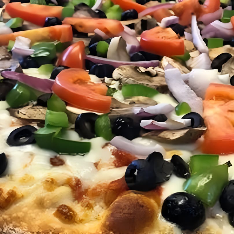Close-up of a Big R's Pizza and Wings pizza with tomatoes, olives, green peppers, onions, and mushrooms.