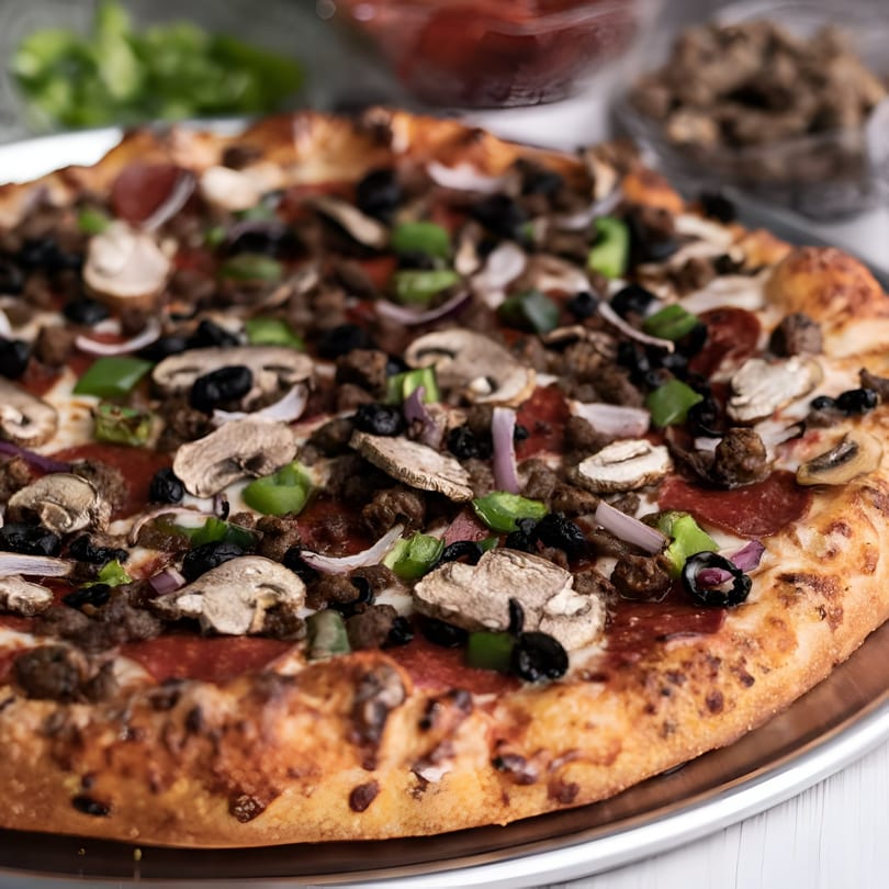 Big R's Pizza and Wings' supreme pizza with pepperoni, sausage, mushrooms, olives, and peppers.